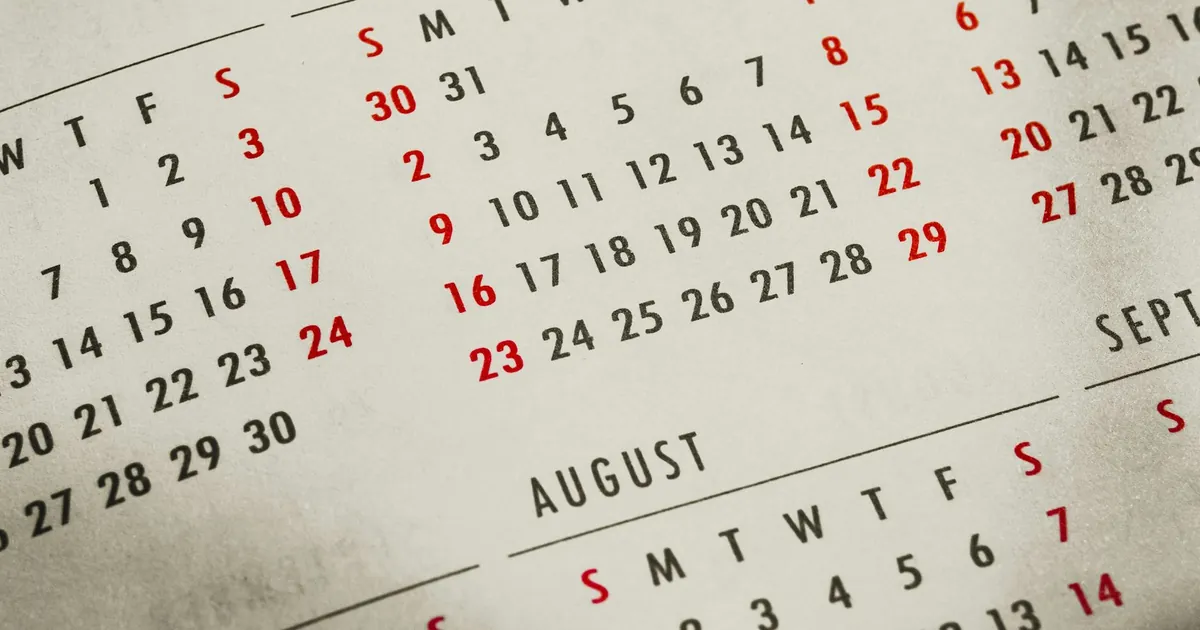 Close-up of a paper calendar with Sundays in red